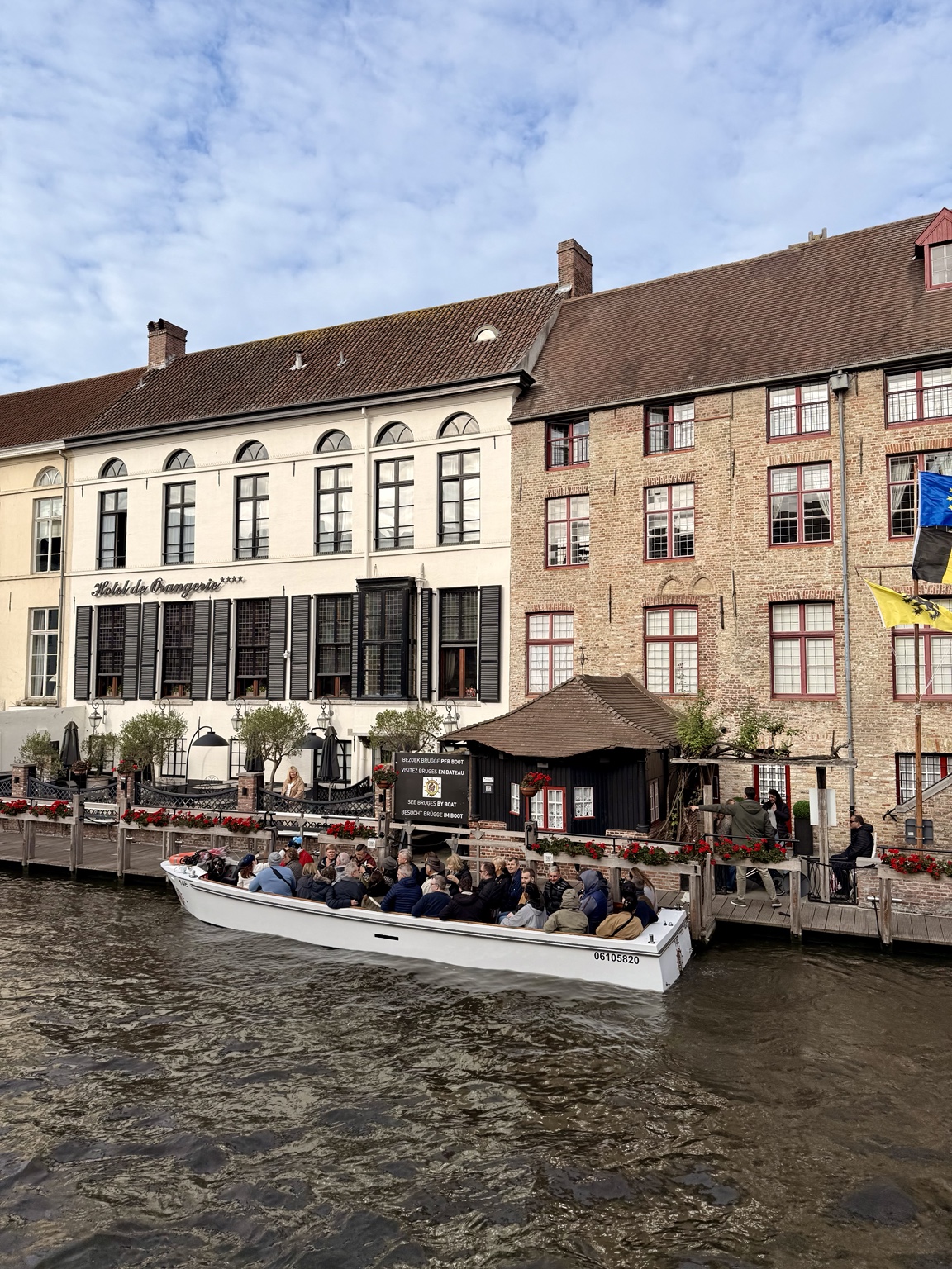 Visitors exploring Bruges by canal boat