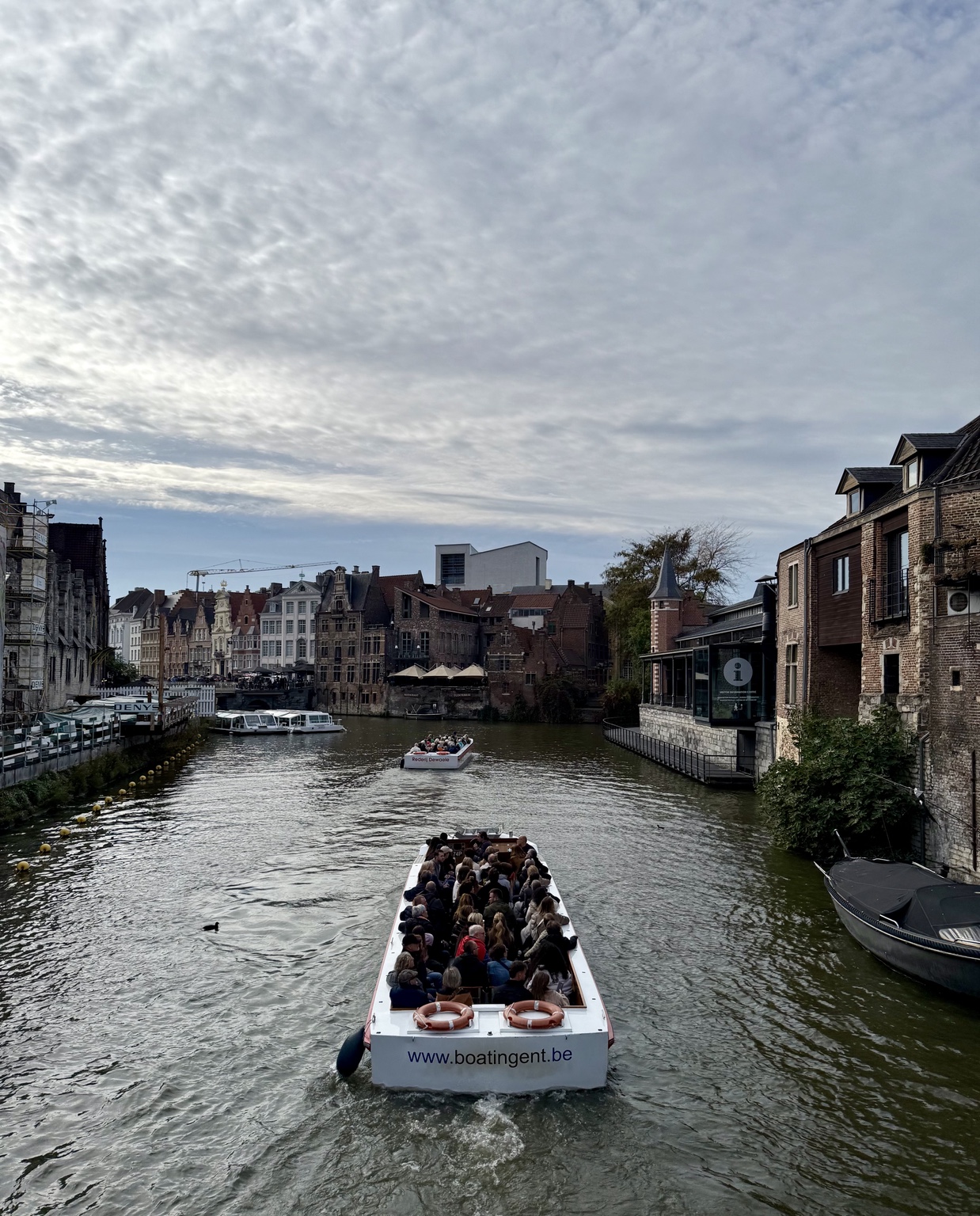 A canal boat moving through historic Ghent