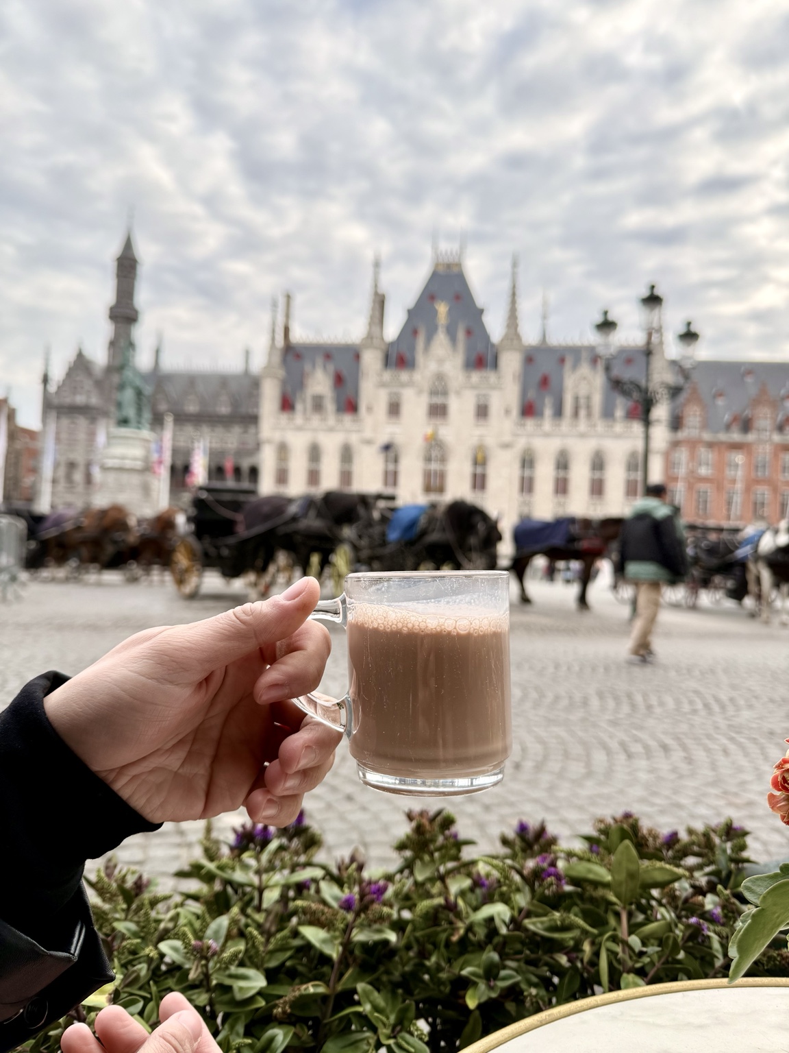 A warm drink overlooking a beautiful Bruges square