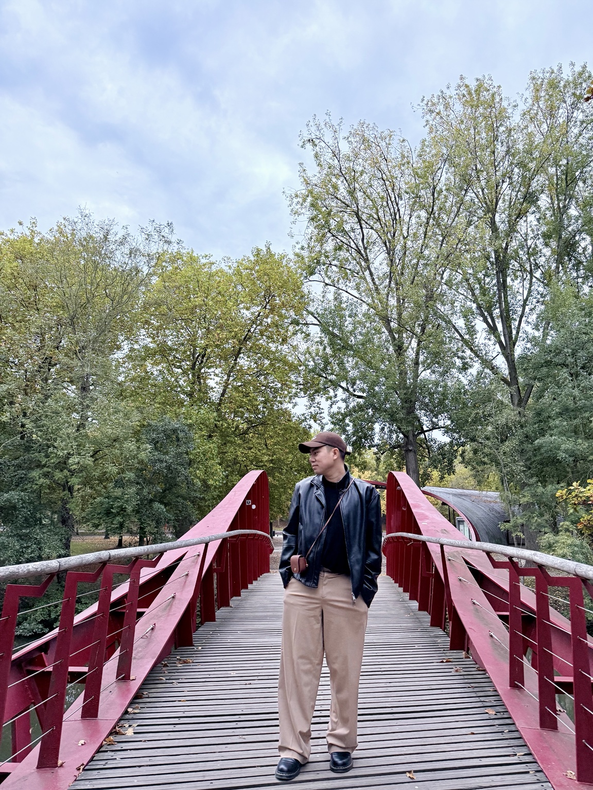 Reymart on a striking red bridge surrounded by nature