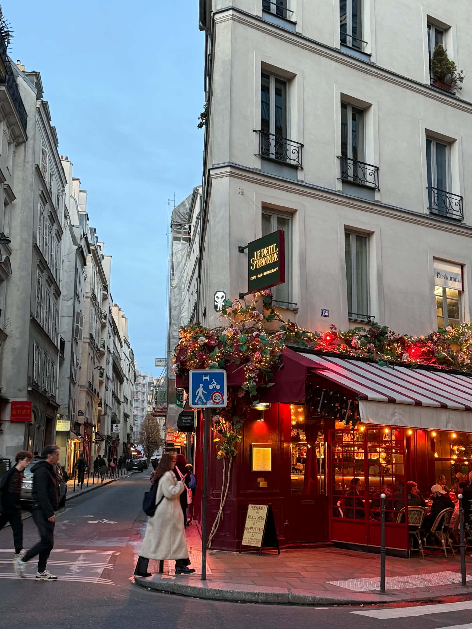 An inviting illuminated café on a Paris corner