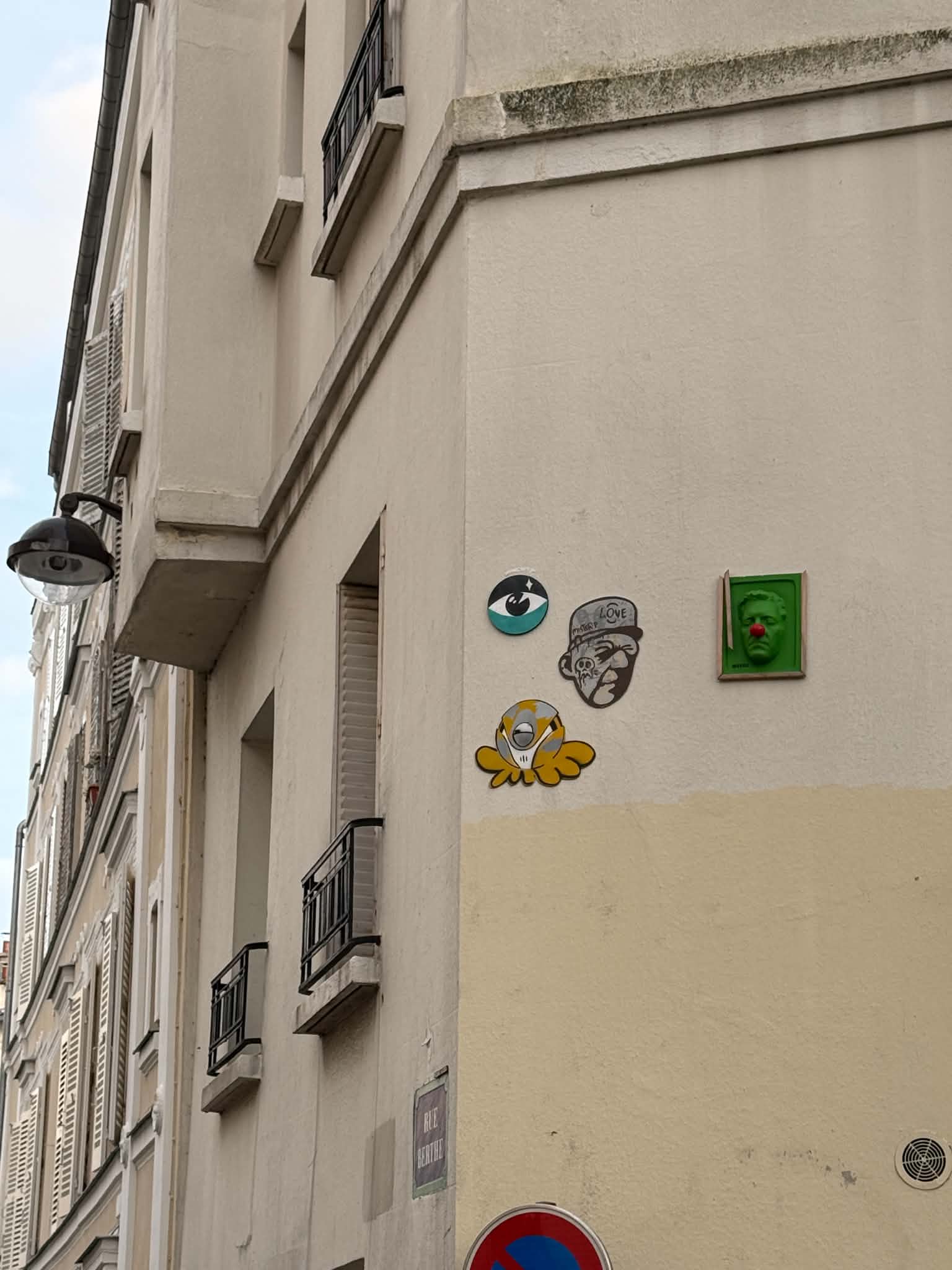 Street art displayed along a Paris wall