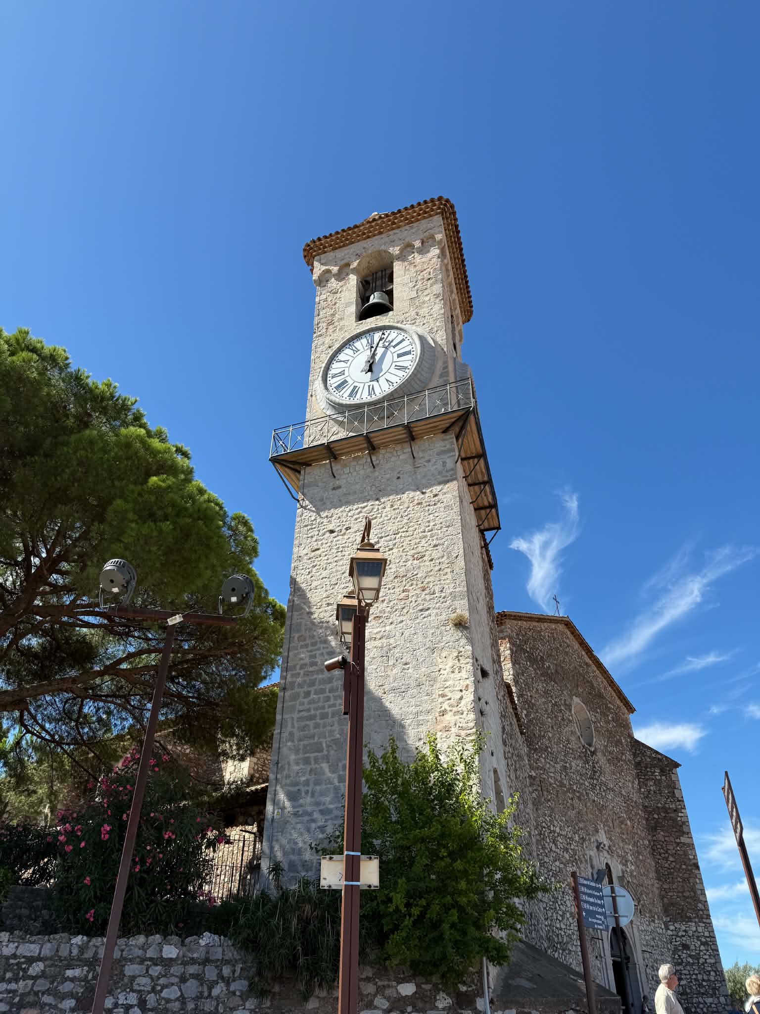A historic clock tower beneath a brilliant blue sky